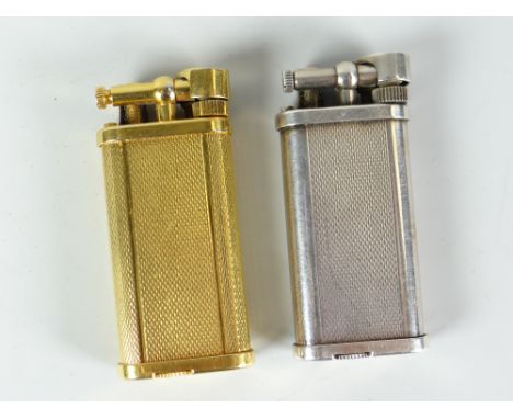 Two Dunhill gas cigarette lighters with white metal and yellow metal engine turned example Condition reports provided on requ