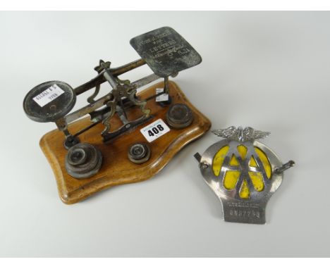 A vintage set of postal-scales on a mahogany base with weights together with an AA vintage grill badge Condition reports prov