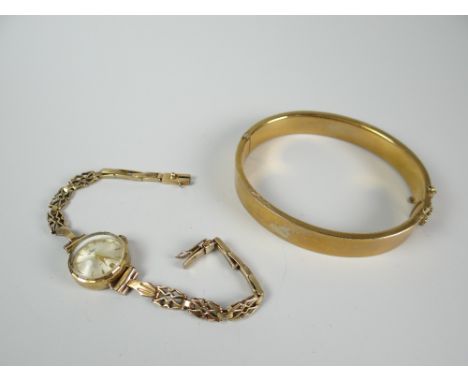An engraved 9ct gold bangle, 13gms and 9k ladies bracelet watch Condition reports provided on request by email for this aucti