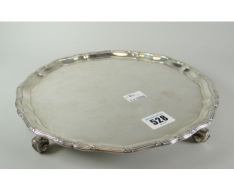 Solid silver salver raised on four scroll-type feet, London hallmarked, maker's J R C A Ltd, 21 troy oz approx., 25.5cms diam