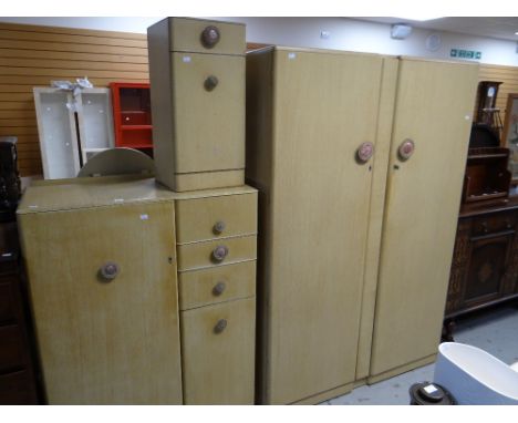 A vintage four-piece painted bedroom set comprising double wardrobe, tallboy, an oval mirrored dressing table with stool &amp