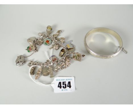 Silver bangle stamped 925 together with silver charm bracelet with assorted charms and heart shaped padlock Condition reports