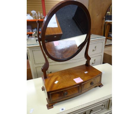 A good antique toilet mirror of oval form with bow-front base having two drawers on bracket feet, 43cms wide Condition report