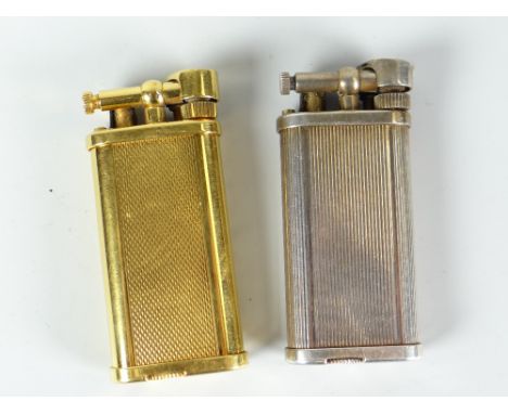 Two Dunhill gas cigarette lighters, gold metal engine turned and white metal ribbed body example Condition reports provided o