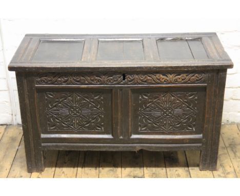 A late 17th century oak coffer, with three plank top and double panel front, on moulded stile feet, 59cm H x 103cm W x 47cm D
