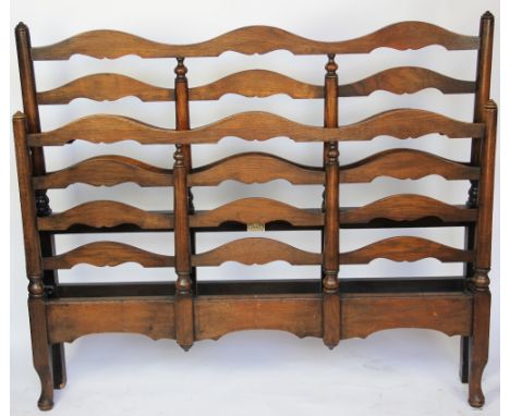 A Heals & Son oak ladder back double / three quarter bed, the head and foot boards in three sections with serpentine cresting