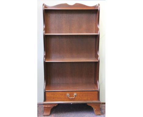 A modern mahogany waterfall bookcase, on bracket feet, 113cm H x 57cm W x 30cm D, and a standard lamp (2)