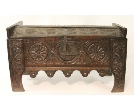 A 16th century riven oak ark or food hutch, the barrel top initialled I.J.K and dated 1548 and with chip carved detailing, wi