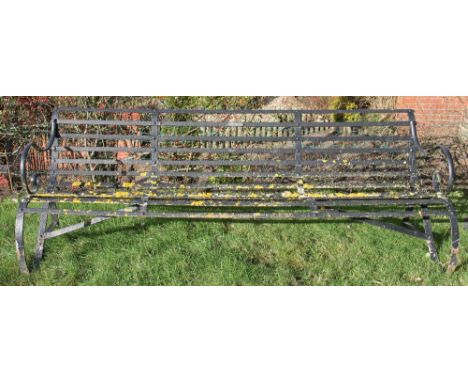 An early 19th century large wrought iron garden bench, possibly Coalbrookdale, of scroll form, 229cm 