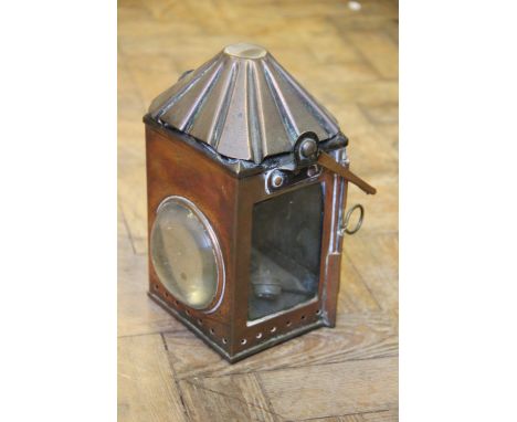 A railway 'Reform Lighting' copper signalling lamp, dated 1915, a cast iron shoe last and two iron laundry irons (4) (as foun