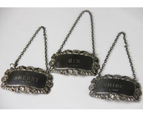 Three silver decanter labels, Richards and Knight, London 1978, including Gin, Whisky and Sherry, 6cm wide and with chain att