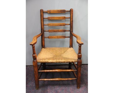 A 19th century oak and ash ladder back chair, with rush seat, two Edwardian oak dining chairs with arms and a pine chair (4)