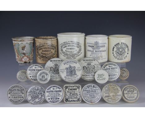 Two trays containing a quantity of pot lids and jars, early 20th century, to include; tooth paste, Cold Cream, Boots, Sainsbu