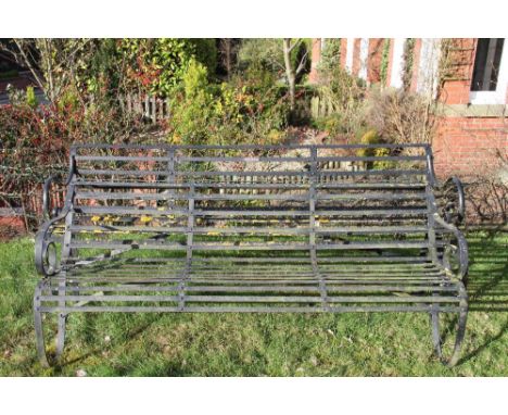 An early 19th century wrought iron garden bench, possibly Coalbrookdale, of scroll form, 184cm