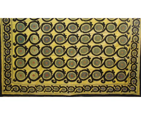 A Mediterranean large textile panel / bed cover, hand worked in wool with flower heads within black scrolls against a yellow 