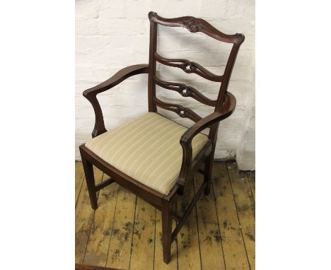 A George III style carved mahogany carver dining chair, with pierced serpentine ladder back