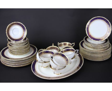A Paragon Athene pattern part dinner service, cobalt, cream and gilt banded, to include; a large oval meat plate, 42cm wide, 
