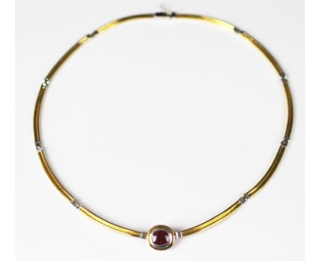 A ruby set collarette necklace, the central oval ruby (measuring approx 1.5ct) collet set in white metal, within yellow metal