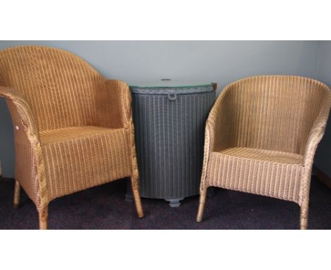A pair of Lloyd Loom tub chairs, two laundry bins and a pine trunk (5)