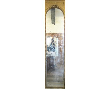 A 19th century carved gilt wood and gesso pier mirror of large proportions, the arched plate surmounted by a bow tied ribbon,