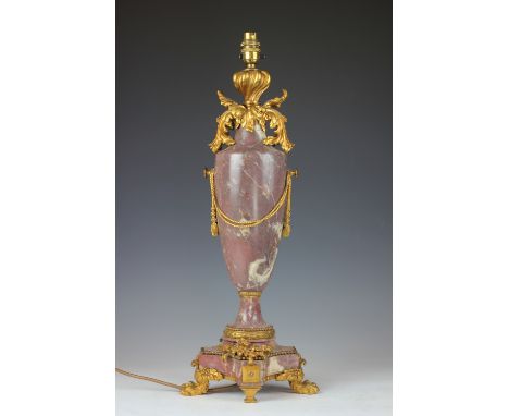 A 19th century French ormolu mounted pale red marble table lamp,  the vase shaped body decorated with rope swags with other f