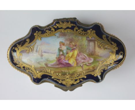 A Sevres porcelain and ormolu trinket box, 19th century, of serpentine form, the cover depicting lovers beside a river, all w