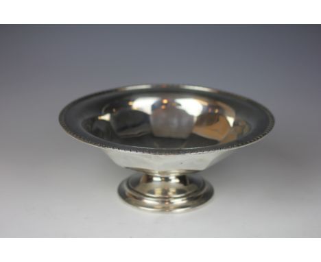 A silver pedestal dish, William Hutton & Sons Ltd, Sheffield 1932, the circular dish with canted detail and faceted rim, 23cm