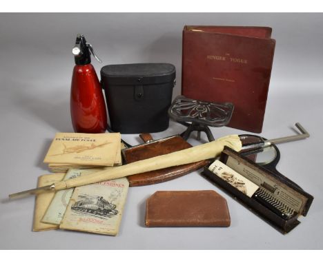 A Box of Sundries to Include Cased Binoculars, Cigarette Card Albums, Iron Trivet Stand, Car Workshop Manual for Singer Vogue