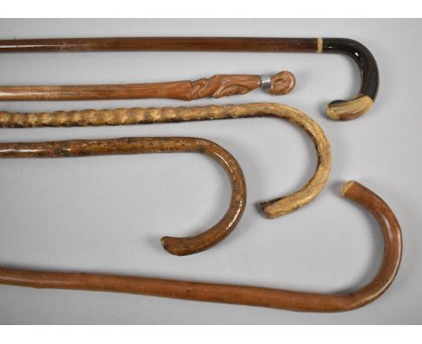 A Collection of Three Wooden Walking Sticks, One Carved African Stick and a Horn Handled Example 