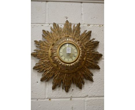 A Smiths electric sunburst wall clock.