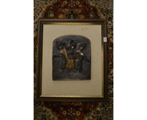 A relief cast bronze plaque of three dancing girls, framed.
