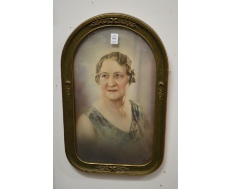 A pair of coloured photographic portrait prints in arched shaped frames with bowed glass.