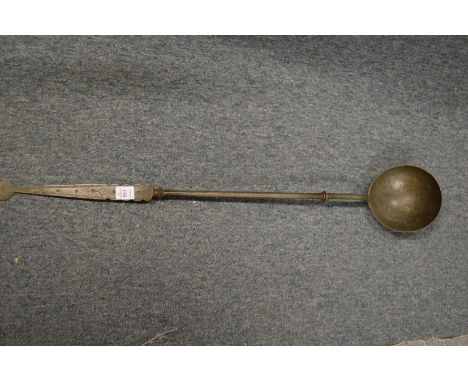 A large Dutch metal ladle.