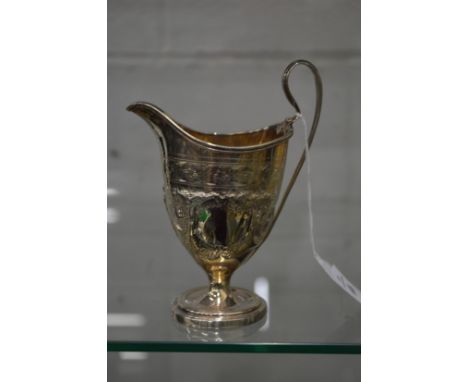 A silver helmet shaped cream jug.