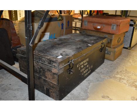 An old metal trunk and three suitcases.