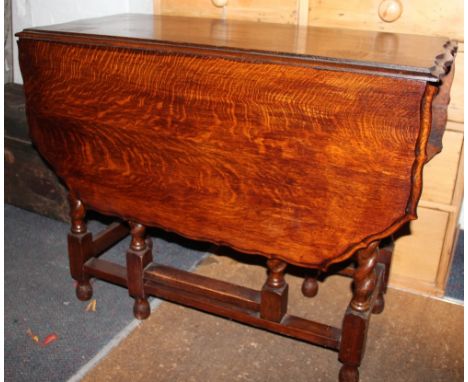 A 1920's oak gate leg table, on barley twist legs, 72cm H x 44cm W x 91cm D