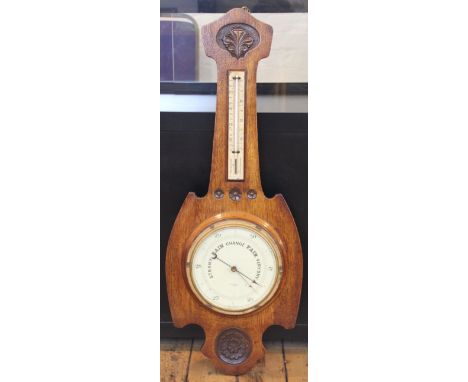 An early 20th century oak cased barometer and thermometer, dial marked Mappin and Webb Ltd, London, the case with carved flor