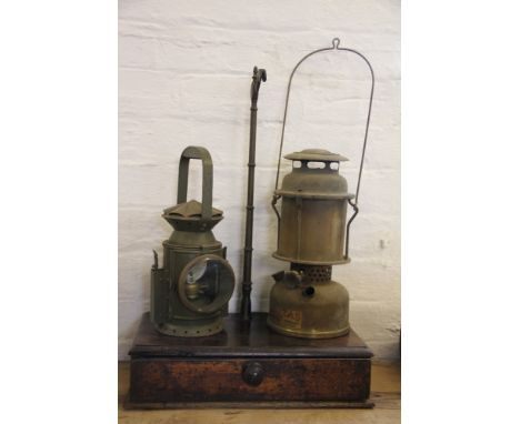 A military issue oil lamp by C E & S, with military arrow stamp and dated 1955, with a Veritas paraffin lamp and a 19th centu