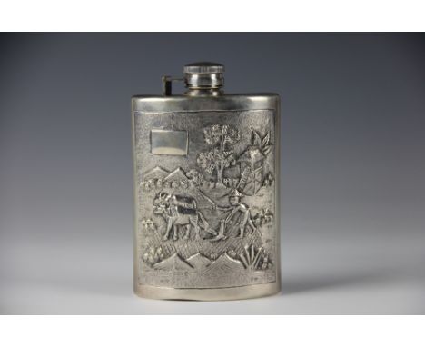 A Burmese sterling silver hip flask, the concave flask with applied cast panels of  farmers ploughing, with elephant and moun