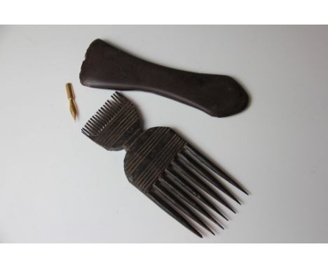 An African carved wood tribal comb, 61.5cm, with a polished stone axe head with initials CMP and date 1677, 17cm (2)