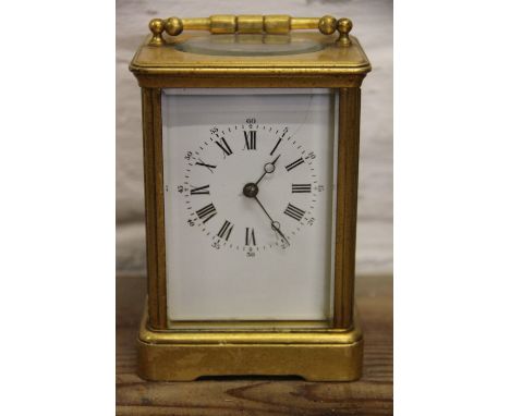 A late 19th century French gilt brass carriage clock, enamel dial with Roman numerals (cracked), and movement stricking on a 