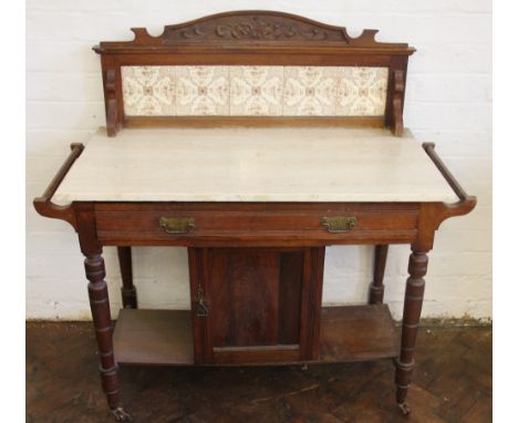 A late Victorian walnut marble top wash stand, with tile back above a drawer and cupboard door, on turned legs, 107cm H x 104