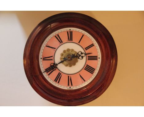 A stained beech postmans clock, with pink and white enamel Roman numeral dial and serpentine Arabic brass centre, and movemen