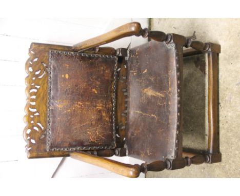 A 1920's oak monks bench with leather upholstry, on turned legs, 71cm high when up
