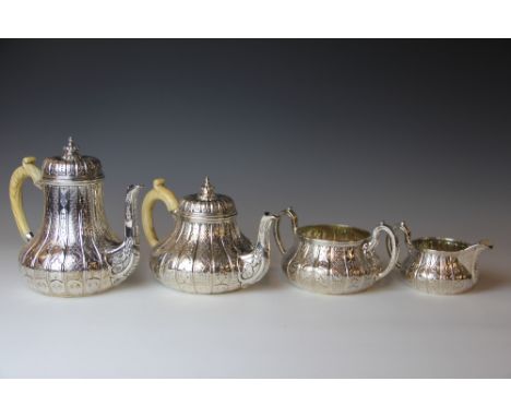 A Victorian silver four piece tea service by John Samuel Hunt, comprising tea pot, hot water pot, sugar bowl and milk jug, ea