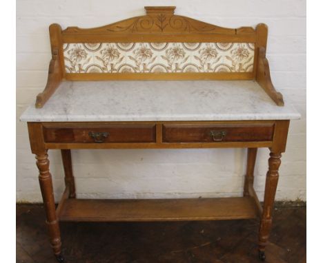 A Victorian pine marble top wash stand, with foliate tile back, above two drawers, on turned legs 110cm H x 106cm W x 48cm D