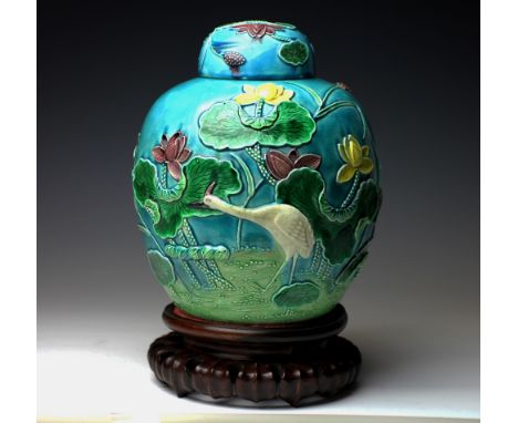 A Chinese Wang Bing Rang ginger jar and cover, moulded with flowers and a wading bird against a green ground, (lid as found),