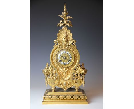 A 19th century French gilt brass eight day mantel clock, enamel Roman numerals and movement striking on a gong, the case with