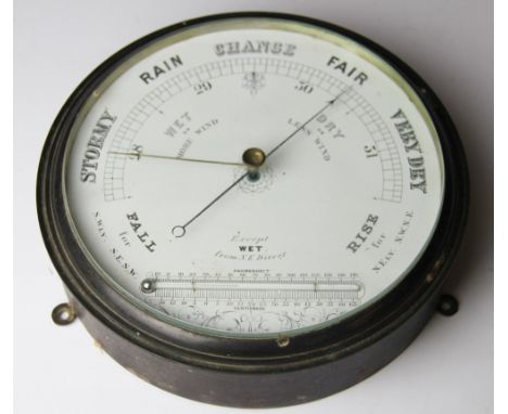 An early 20th century brass barometer, with thermometer set dial, 22.5cm
