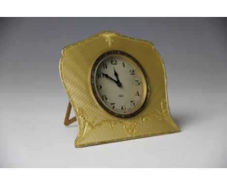 A George V silver and yellow enamel eight day timepiece, Arthur Cook, Birmingham 1929, the Arabic dial within a serpentine fr